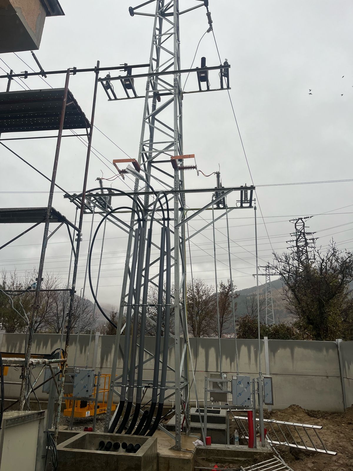 MV cables rising up a lattice steel substation gantry to terminations and surge arresters