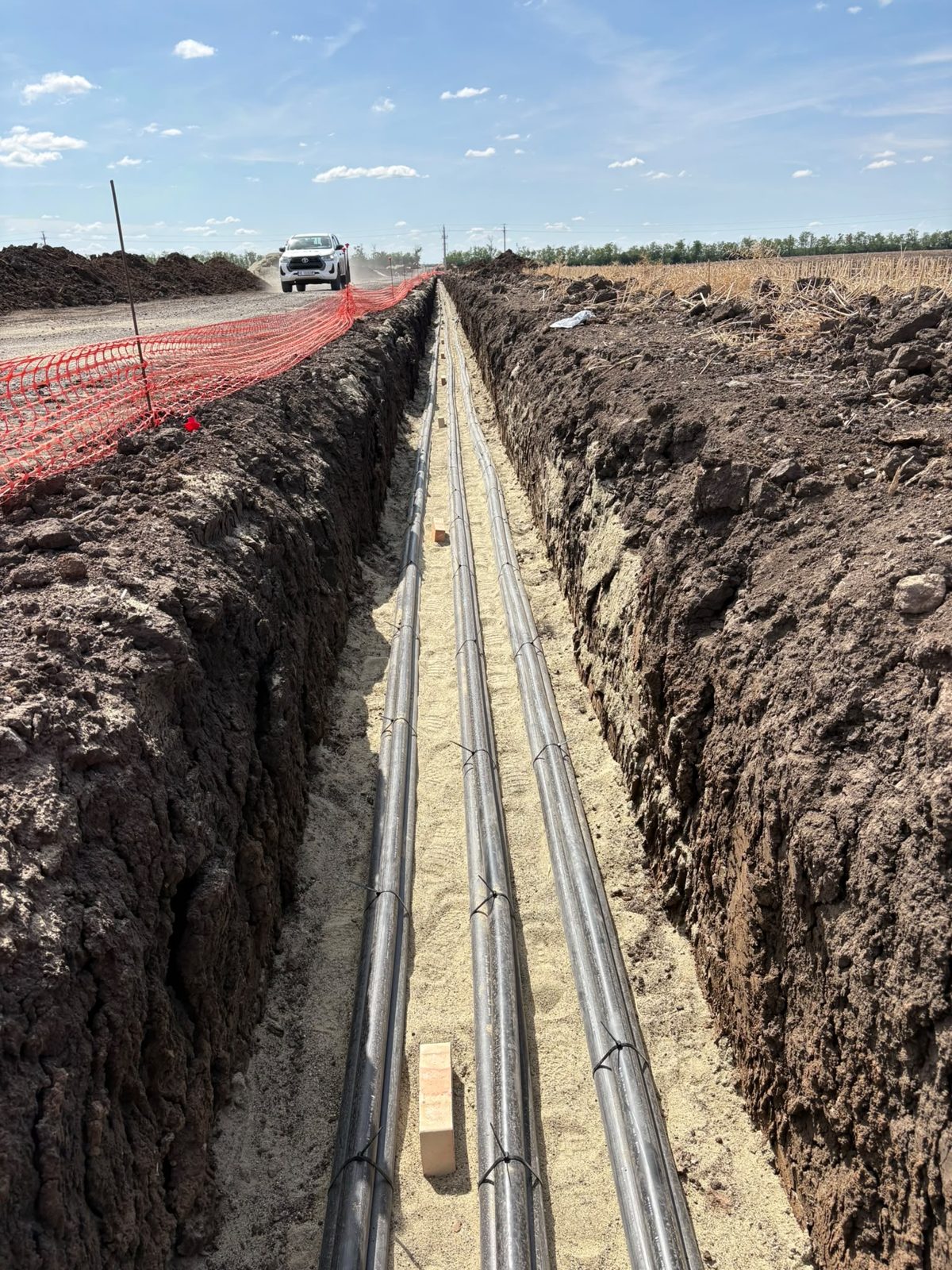 MV cable conduits laid on sand bedding in an open trench